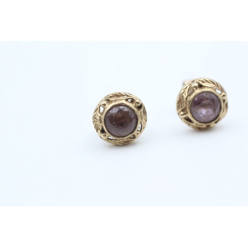 147 - A PAIR 9CT GOLD FLOIATE FRAMED AMETHYST SET STUD EARRINGS Weight: 2.4gms