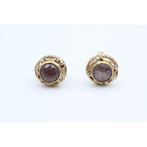 147 - A PAIR 9CT GOLD FLOIATE FRAMED AMETHYST SET STUD EARRINGS Weight: 2.4gms