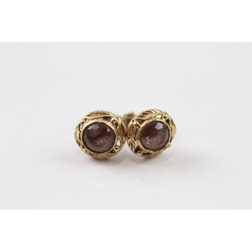 147 - A PAIR 9CT GOLD FLOIATE FRAMED AMETHYST SET STUD EARRINGS Weight: 2.4gms