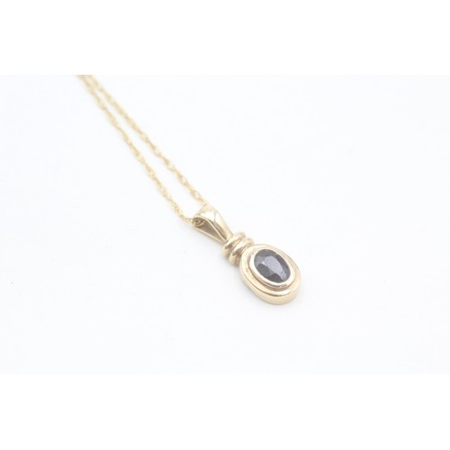 155 - A 9CT GOLD OVAL CUT SAPPHIRE PENDANT NECKLACE Weight: 1.9gms