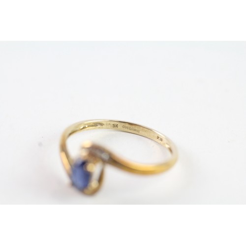 162 - A 9CT GOLD OVAL BLUE GEMSTONE AND DIAMOND DRESS RING Weight: 1.7 gms