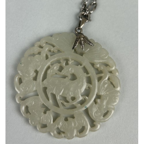 186 - A CHINESE JADE RETICULATED DISC POSSIBLY LATE 19TH CENTURY WITH SILVER CHAIN Weight: 42.1gms