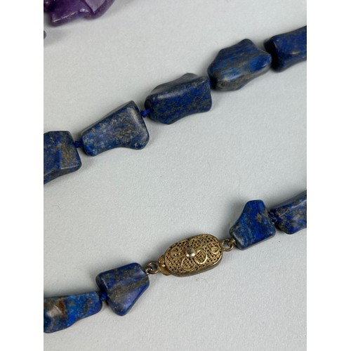 202 - A CHINESE LAPIS LAZULI NECKLACE ALONG WITH A PURPLE STONE NECKLACE