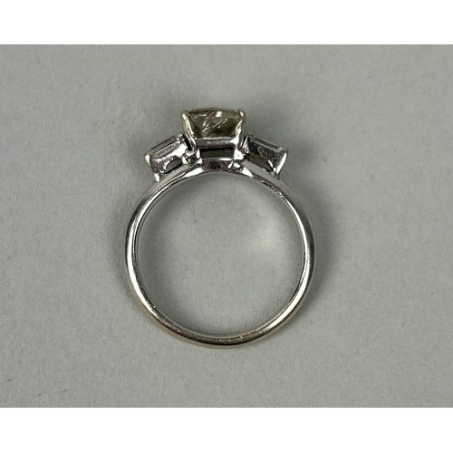 209 - A TRAPEZE CUT DIAMOND THREE STONE PLATINUM RING Center stone approximately 1ct Weight: 2.6 gms