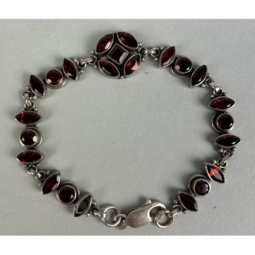 218 - A SILVER BRACELET SET WITH RED STONES One stone missing.