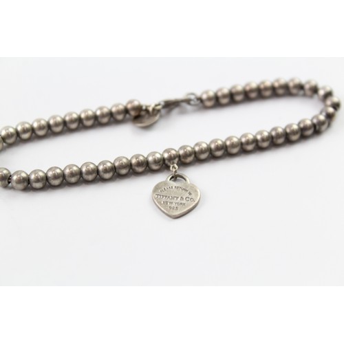 244 - A TIFFANY AND CO STERLING SILVER BALL LINK BRACELET WITH A HEART TAG Weight: 6gms