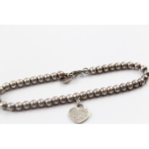 244 - A TIFFANY AND CO STERLING SILVER BALL LINK BRACELET WITH A HEART TAG Weight: 6gms