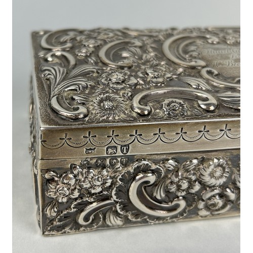 281 - A SILVER CIGARETTE BOX WITH FLORAL REPOUSSE DESIGN 18cm x 9cm x 5cm