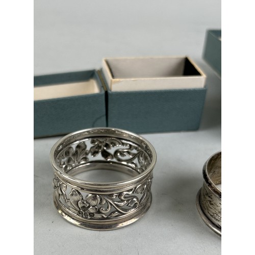 295 - FIVE SILVER NAPKIN RINGS THREE WITH BOXES (5) To include one with good floral design. Total weight: ... 