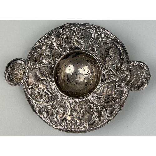 307 - A SILVER STRAINER WITH REPOUSSE DECORATION OF FIGURES Weight: 98gms 14cm L