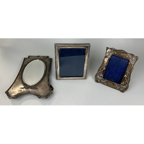 308 - THREE SILVER PICTURE FRAMES ONE ARTS AND CRAFTS Largest 29cm x 22cm (back needs repair to be used pr... 