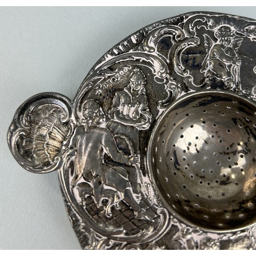 307 - A SILVER STRAINER WITH REPOUSSE DECORATION OF FIGURES Weight: 98gms 14cm L