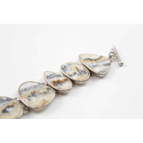 418 - A STERLING SILVER BANDED RUTILATED AGATE BRACELET Weight: 37gms