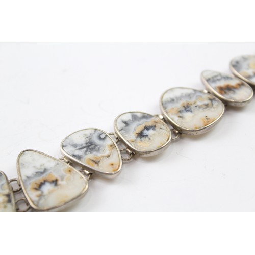 418 - A STERLING SILVER BANDED RUTILATED AGATE BRACELET Weight: 37gms