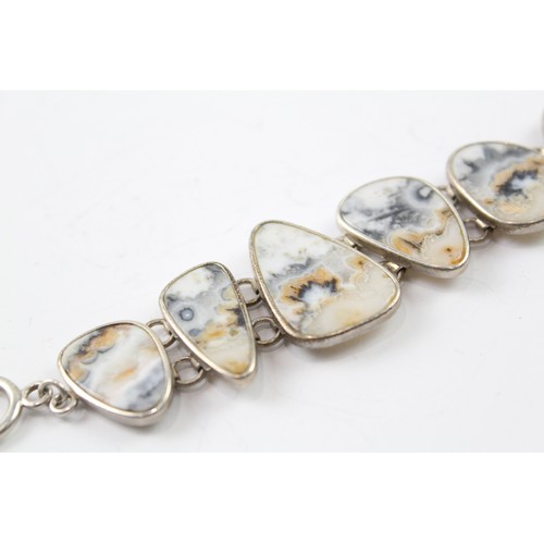 418 - A STERLING SILVER BANDED RUTILATED AGATE BRACELET Weight: 37gms