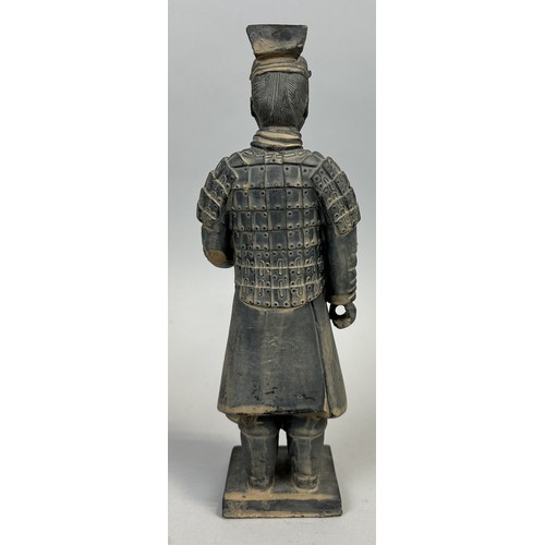 582 - A CHINESE TERRACOTTA FIGURE OF A SOLDIER 26cm H