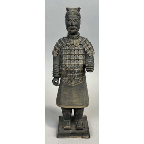 582 - A CHINESE TERRACOTTA FIGURE OF A SOLDIER 26cm H