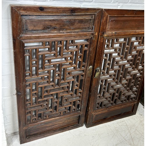 584 - A PAIR OF ANTIQUE CHINESE ROSEWOOD RETICULATED DOOR PANELS 83cm x 45cm each.