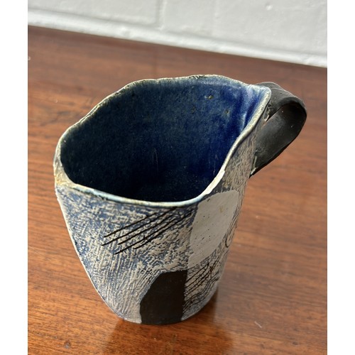 644 - JOHN MALTBY: A STUDIO POTTERY JUG 14cm x 13cm Some chips