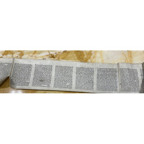 643 - A JEWISH SCROLL 270cm x 21cm With walnut veneer case with glass lid.