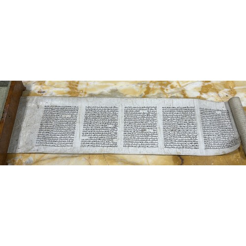 643 - A JEWISH SCROLL 270cm x 21cm With walnut veneer case with glass lid.