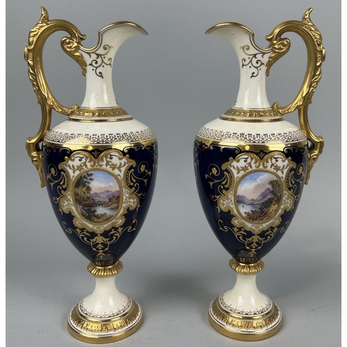 667 - A PAIR OF COALPORT PORCELAIN EWERS BLUE GROUND WITH GILT AND CENTRAL PAINTED PANELS DEPICTING LANDSC... 