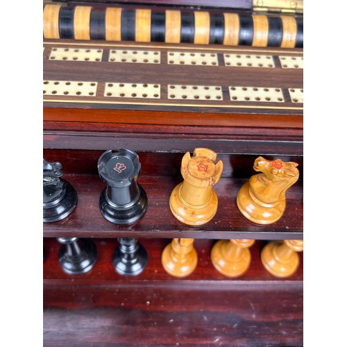 684 - AN EARLY VICTORIAN MAHOGANY BOXED GAMES COMPENDIUM WITH STAUNTON CHESS PIECES

With chess (staunton ... 