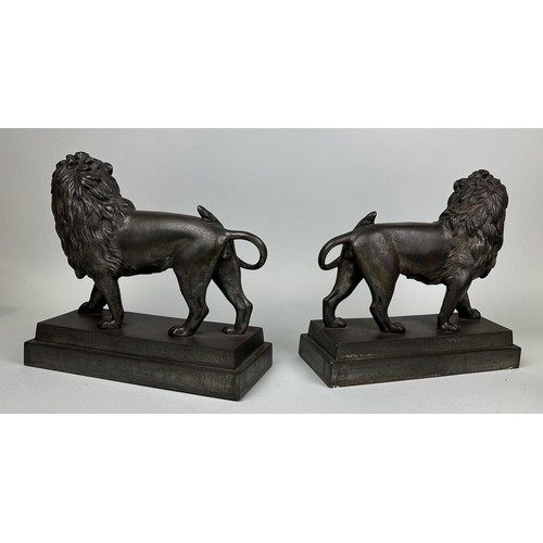 676 - A PAIR OF LARGE CAST METAL LIONS 29cm x 27cm x 11cm each.