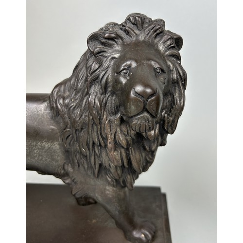 676 - A PAIR OF LARGE CAST METAL LIONS 29cm x 27cm x 11cm each.