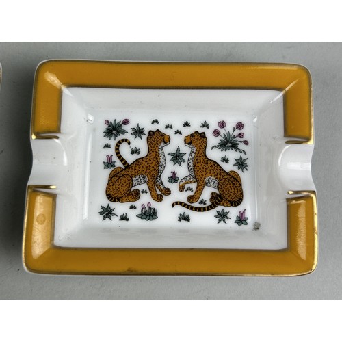 689A - A PAIR OF HERMES LIMOGES PORCELAIN TRINKET DISHES DECORATED WITH LEOPARDS 8cm x 6cm each.