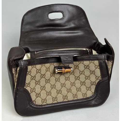 688 - A GUCCI HANDBAG WITH BAMBOO HANDLE AND CLASP, MONOGRAM 31cm L