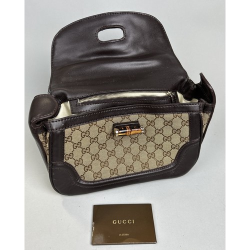 688 - A GUCCI HANDBAG WITH BAMBOO HANDLE AND CLASP, MONOGRAM 31cm L