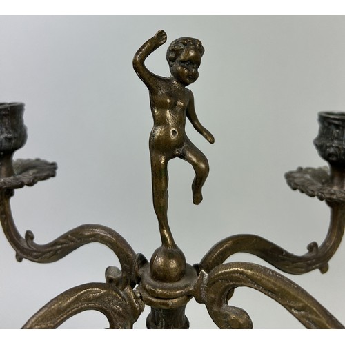 990 - A NEAR PAIR OF BRONZE TABLE LAMPS WITH CUPID FINIALS 32cm H each.