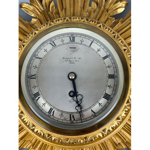 1042 - A GARRARD AND CO GILT WOOD SUNBURST WALL CLOCK 63cm x 46cm