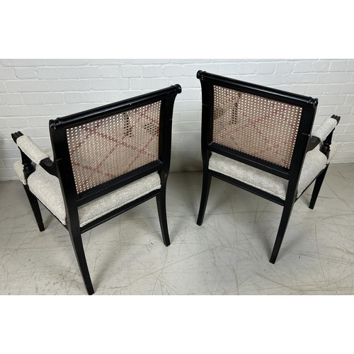 1044 - A PAIR OF EBONISED BLACK ARMCHAIRS WITH CANED BACKS 93cm x 53cm x 53cm