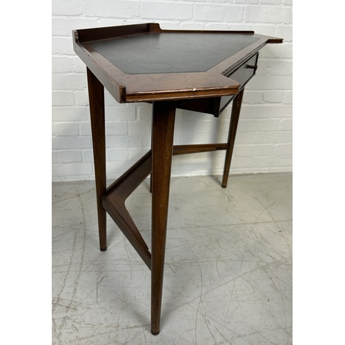 1145 - A MID-CENTURY WRITING DESK, IN THE STYLE OF GORDON RUSSELL (1892-1980) Teak, brass and black leather... 