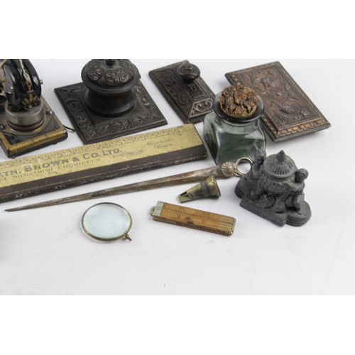 1197 - ANTIQUE DESKTOP ITEMS INCLUDING INKWELLS , EMBOSSER, PAPERWEIGHT, SHARPENER