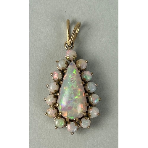 36 - AN 18CT GOLD PENDANT SET WITH A PEAR CUT OPAL SURROUNDED BY SMALL OPALS

Weight: 5.4gms