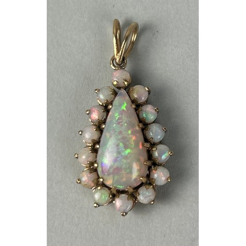 36 - AN 18CT GOLD PENDANT SET WITH A PEAR CUT OPAL SURROUNDED BY SMALL OPALS

Weight: 5.4gms