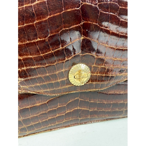 153 - AN ASPREY LONDON CROCODILE SKIN BAG WITH 9CT GOLD CLASP
Hallmarked 9ct.
26cm x 18cm... 