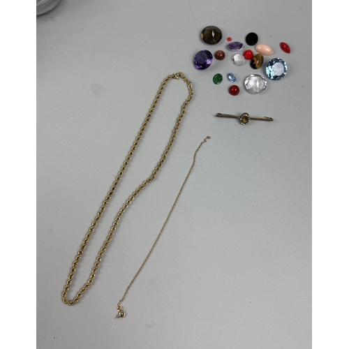 165 - A 9CT GOLD CHAIN ALONG WITH A SMALL 18CT GOLD BRACELET, A BASE METAL PIN AND VARIOUS LOOSE STONES
We... 