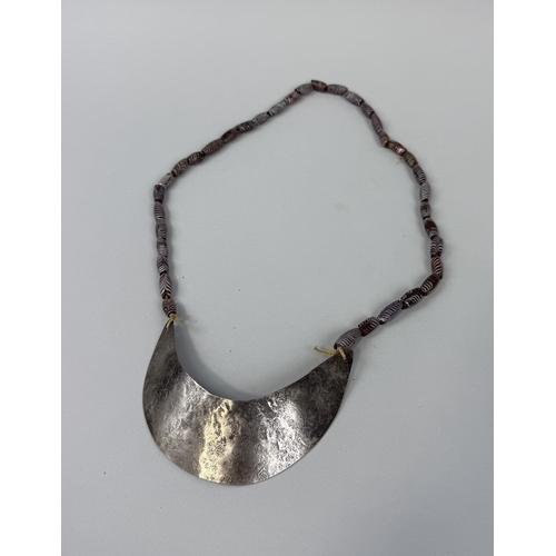 177 - A HUDSON BAY SILVER FUR TRADE GORGET ALONG WITH MURANO CHEVRON TRADE BEAD NECKLACE
Longest 42cms.... 