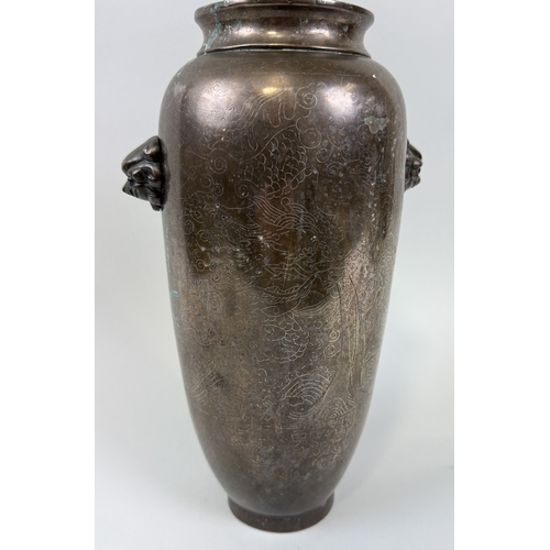 201 - A CHINESE 19TH CENTURY BRONZE VASE WITH LION HEAD HANDLES
30cm x 16cm