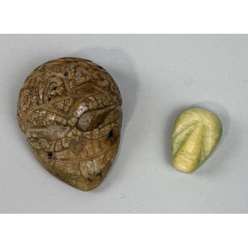 288 - A SOUTH AMERICAN BONE SKULL ALONG WITH A CARVED STONE HEAD
Largest 6cm L