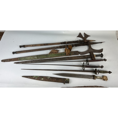 306 - A COLLECTION OF ANTIQUE MILITARIA TO INCLUDE DAGGERS, SWORDS, AXES AND FOILS
One dagger possibly Per... 