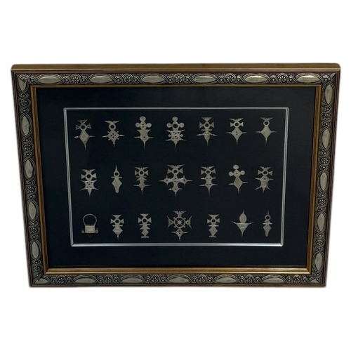 92 - A FRAMED SET OF TWENTY ONE SILVER AGADEZ CROSSES
Frame 58cm x 48cm