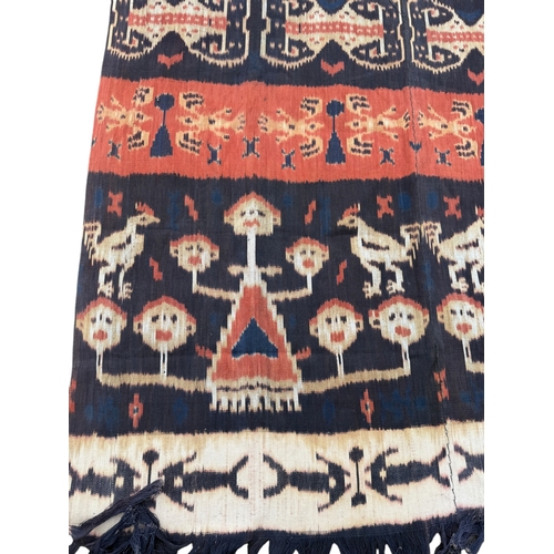 117 - AN INDONESIAN SUMBA IKAT TEXTILE DECORATED WITH FIGURES
240cm x 110cm