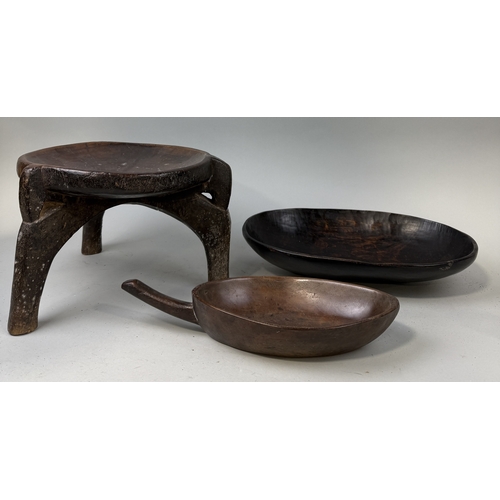 130 - AN AFRICAN HARD WOOD THREE LEG MILKING STOOL ALONG WITH TWO WOODEN DISHES
Stool 30cm x 22cm... 