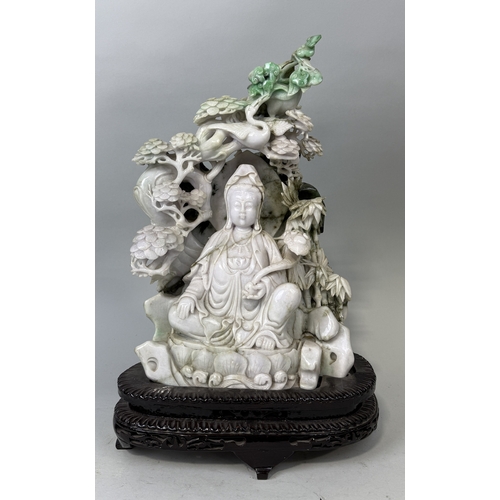 148 - A CHINESE JADE SCULPTURE DEPICTING THE SEATED GUANYIN WITH RUYI SCEPTRE, SURROUNDED BY BAMBOO SHOOTS... 