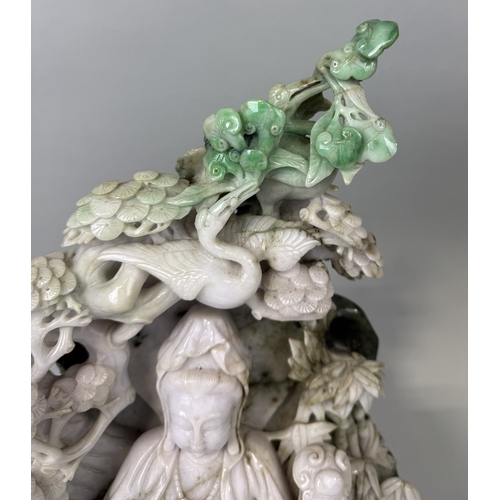 148 - A CHINESE JADE SCULPTURE DEPICTING THE SEATED GUANYIN WITH RUYI SCEPTRE, SURROUNDED BY BAMBOO SHOOTS... 